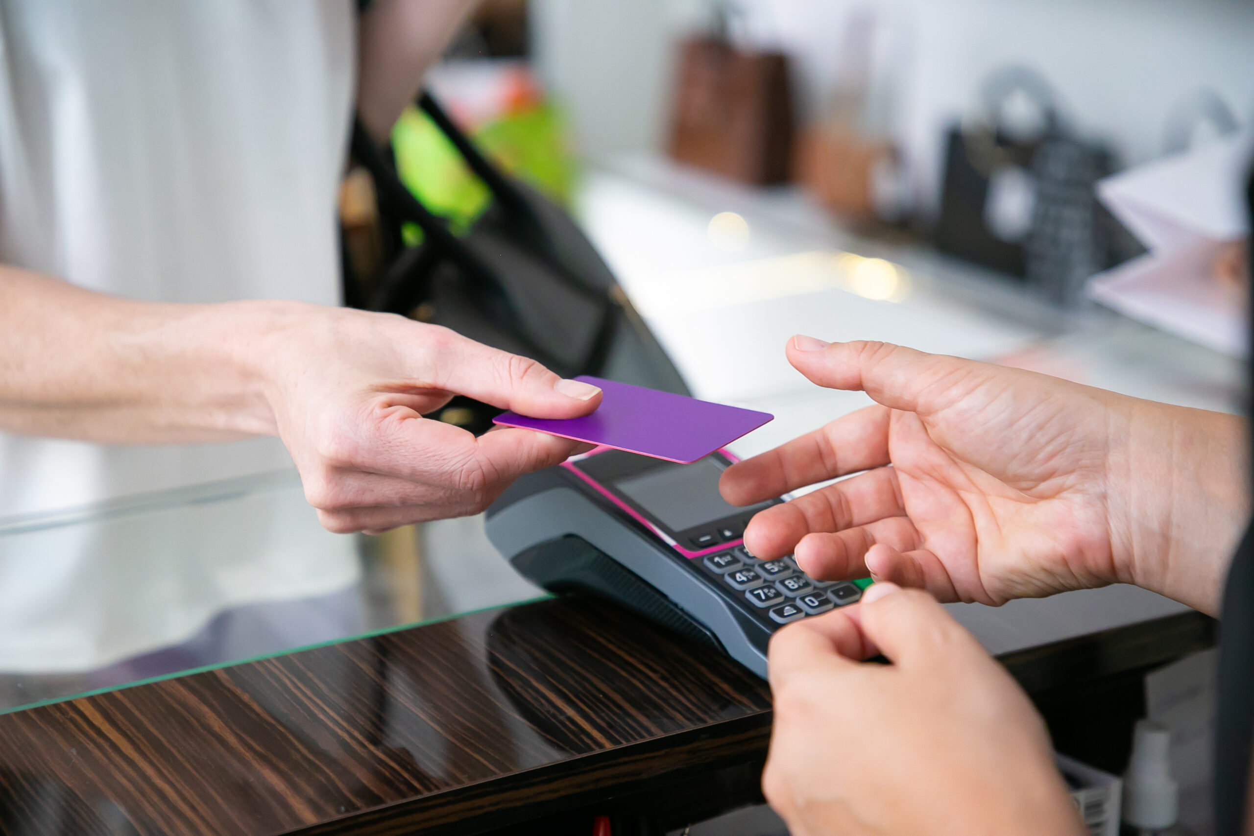 Customer giving credit card to cashier